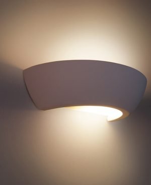 The Cleoni Dinas Wall Light is a circular wall fitting in ceramic white that provides bidirectional ambient lighting.