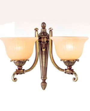 The Riperlamp Bologna Wall Light features a traditional design with two floral inspired acid amber glass lampholders. Each lampholder is supported by a curved metal arm attached to a metal base in bronze finish.