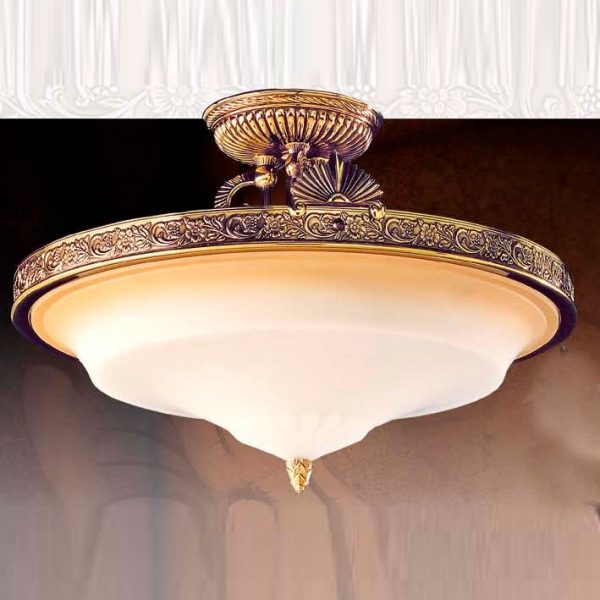 The Riperlamp Esparta Ceiling Light features a curved amber glass diffuser and bronze metal base with repeating floral motifs.
