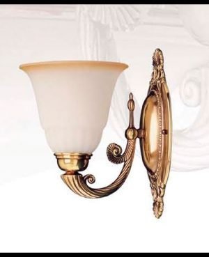 The Riperlamp Esparta Single Wall Light features a traditional design with an amber glass lamp holder supported by a decorative metal arm and base in bronze finish.