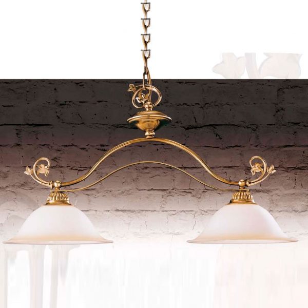 The Riperlamp Galia Pendant is a traditional style pendant with two amber glass curved lamp holders supported by an elegant metal arm and chain link suspension finished in old brass.