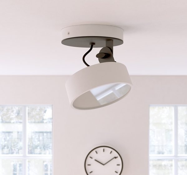 The Cleoni Dot Ceiling Spotlight is a surface fitted light with circular, adjustable lamp. Shows the spotlight installed in a white, modern room. White aluminium finish. Requires 10W LED light source (included).