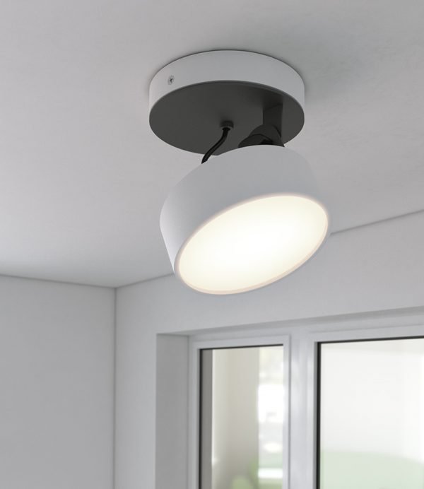 The Cleoni Dot Ceiling Spotlight is a surface fitted light with circular, adjustable lamp. Shows the spotlight turned on. White aluminium finish. Requires 10W LED light source (included).