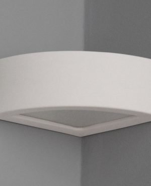 The Omega G Corner wall light is a circular wedge corner light that fits snugly into a standard 90° room corner. Made with white ceramic which can be painted in any colour. Provides ambient illumination. Requires an E14 light source.