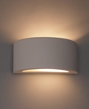 The Cleoni Omega J Wall Light features a half spherical, wedge design with a small cut out at the bottom to allow bidirectional lighting, made with white ceramic.