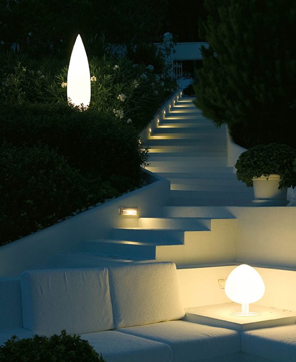 Two Vibia Tree Outdoor Lights in both large and small sizes among outdoor stairs and hedges.